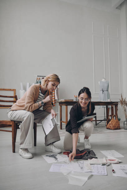 istock Two confident female fashion designers examining sketches while working in workshop 1484322915
