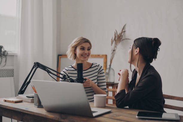 istock Two confident young women communicating while providing live stream in studio together 1484324832
