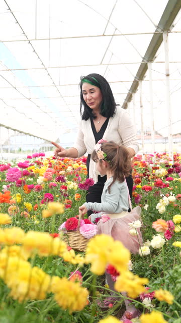 4K video of mother and daughter in flower graden