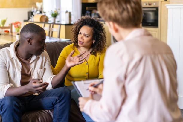 istock Husband talking to wife during therapy session 1484331345
