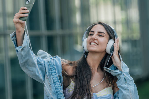 istock influencer with mobile phone and headphones 1484332935