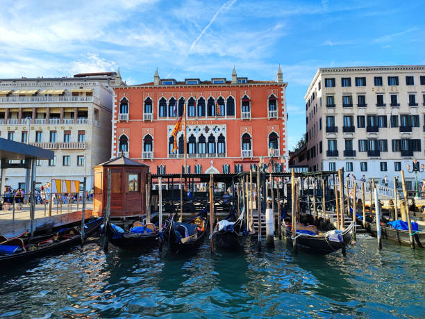 gondolas in front of a historic house facade in venice stock photo