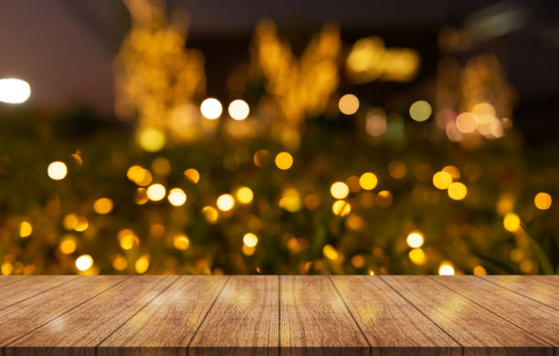 istock Empty wooden table top with lights bokeh on blur restaurant background. 1484336949