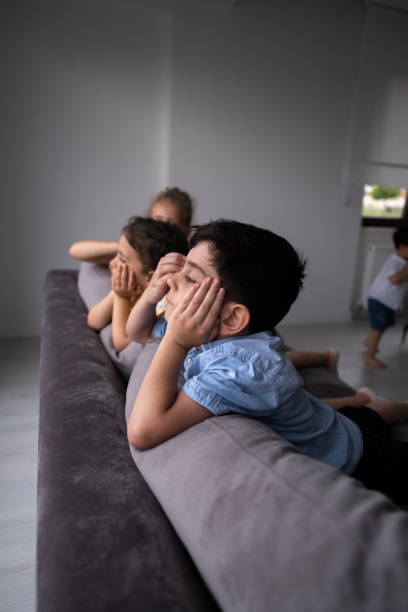 istock Little children watching the rain through the window 1484338643