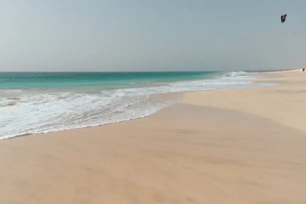 Photo of Calm waves lap the beach