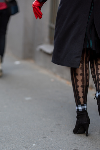 Woman's legs with ornate patterned pantyhose in black