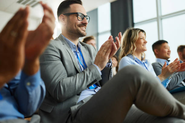 istock Happy entrepreneurs applauding on successful education event in board room. 1484339531