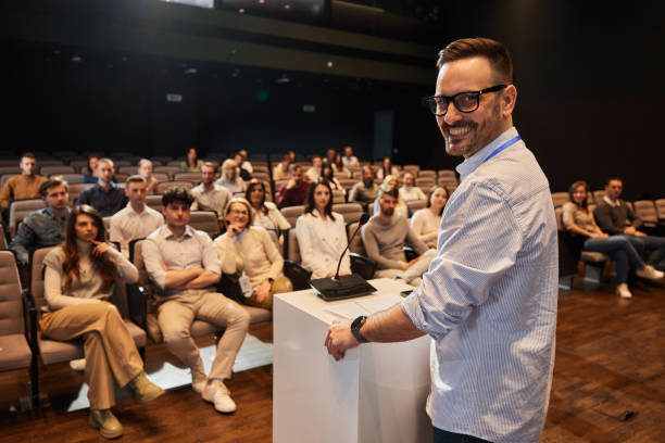 istock Happy public speaker on education event in convention center. 1484339618
