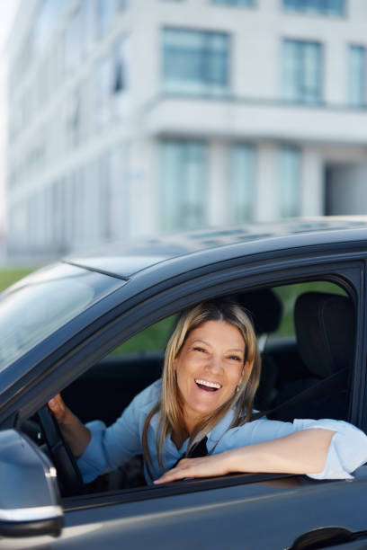 istock Happy businesswoman enjoying while driving a car. 1484339827