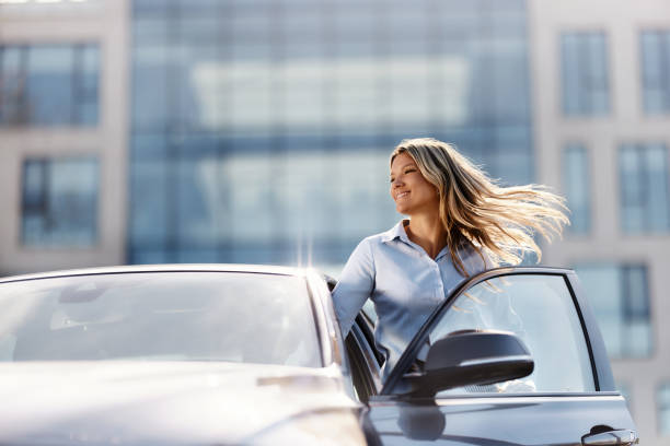 istock Happy female entrepreneur entering the car. 1484341342
