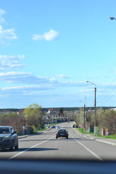 istock Blue sky, road, spring, cars, green grass 1484351603