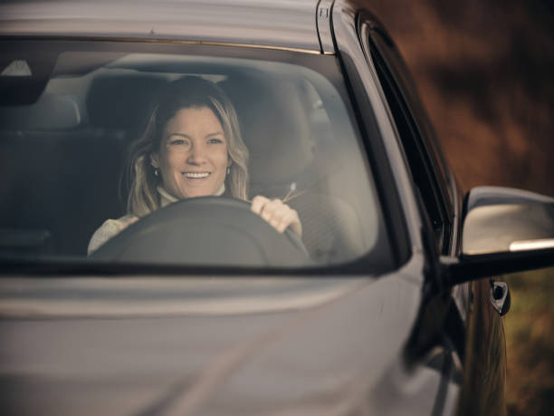 istock Happy woman driving a car. 1484358452