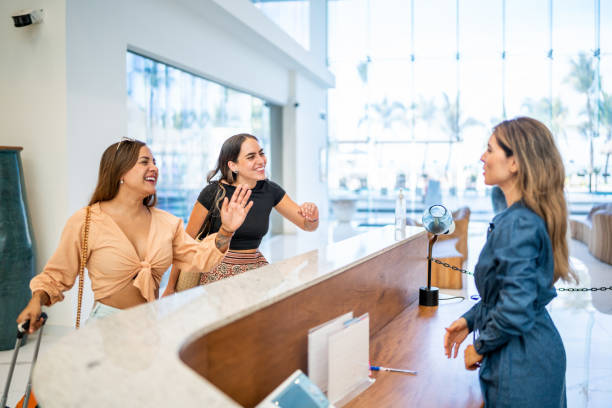 Customers greeting hotel receptionist at lobby