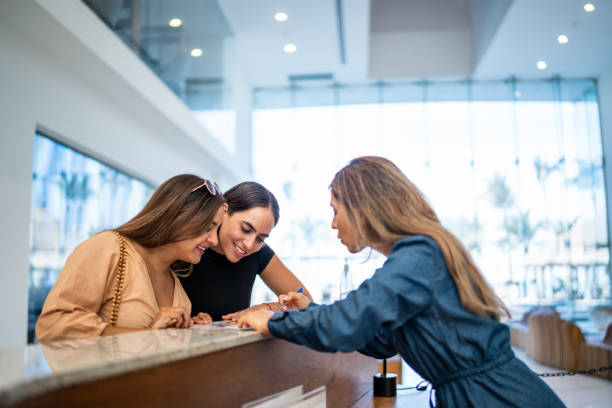 istock Receptionist talking customers at hotel lobby 1484360613