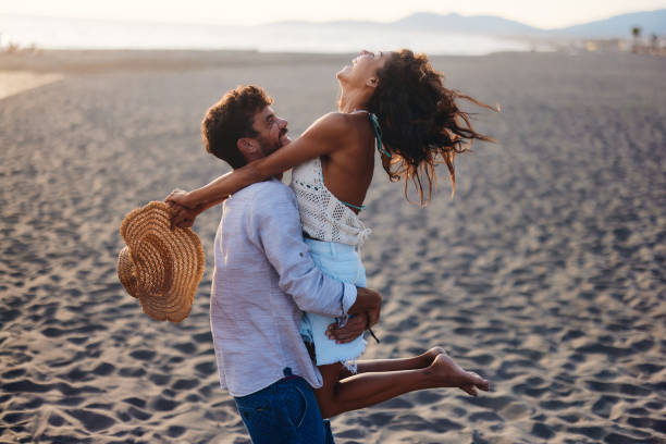 istock Carefree couple having fun on the beach. 1484360625
