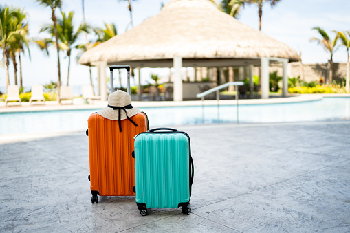 Wheeled luggage by the pool on a resort