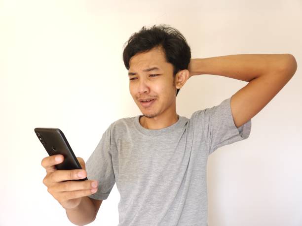 istock sad man looking at his phone screen 1484361145