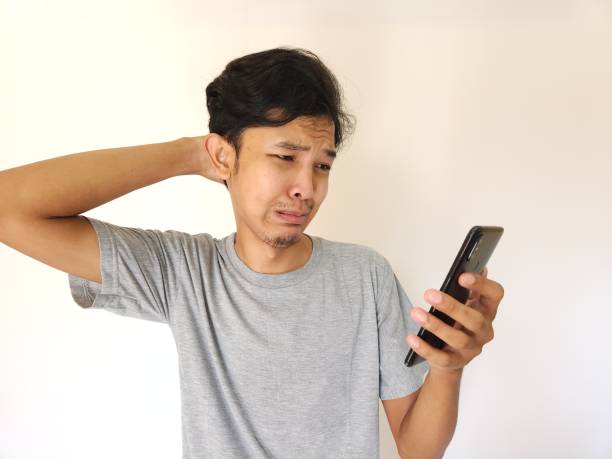 istock sad man looking at his phone screen 1484361158