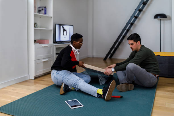 istock A happy multiracial couple is assembling a new table in a new home. 1484363505
