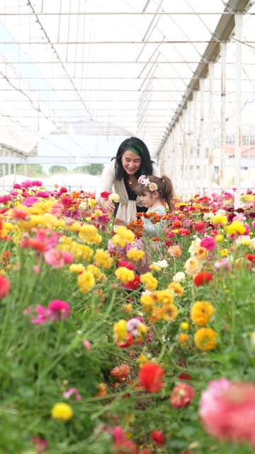 4K video of mother and daughter in flower graden