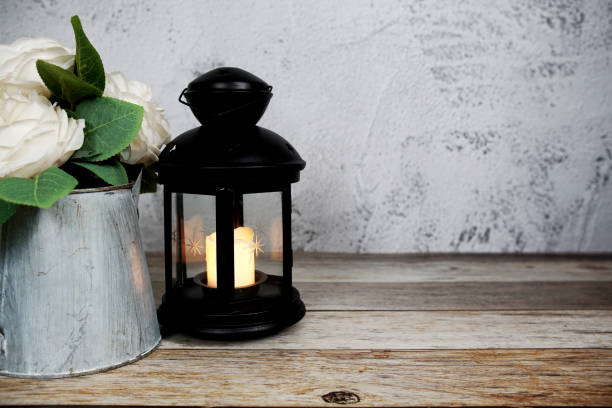 istock Black Lantern with LED candle light home decoration on wooden background 1484390318