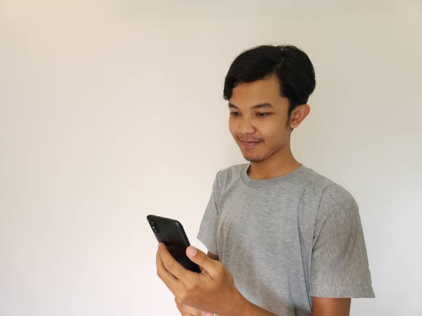 istock Wow and surprise face asian man use smartphone with copy space of advertisement 1484390325