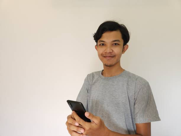 istock Wow and surprise face asian man use smartphone with copy space of advertisement 1484390393