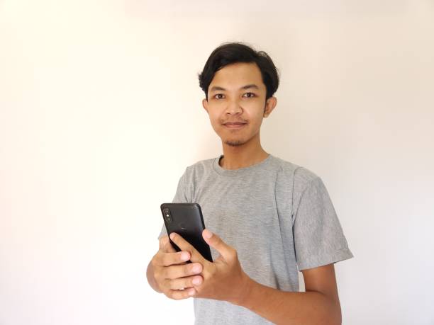 istock Wow and surprise face asian man use smartphone with copy space of advertisement 1484390919
