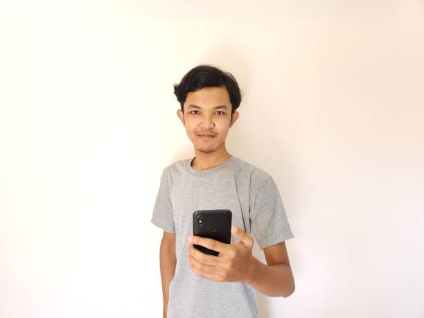 istock Wow and surprise face asian man use smartphone with copy space of advertisement 1484390932