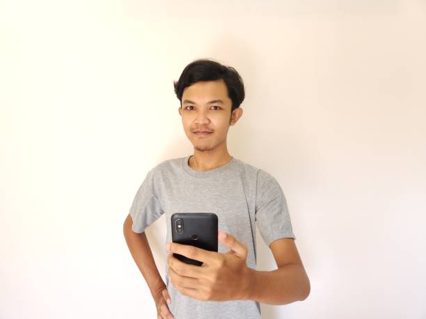 istock Wow and surprise face asian man use smartphone with copy space of advertisement 1484390945
