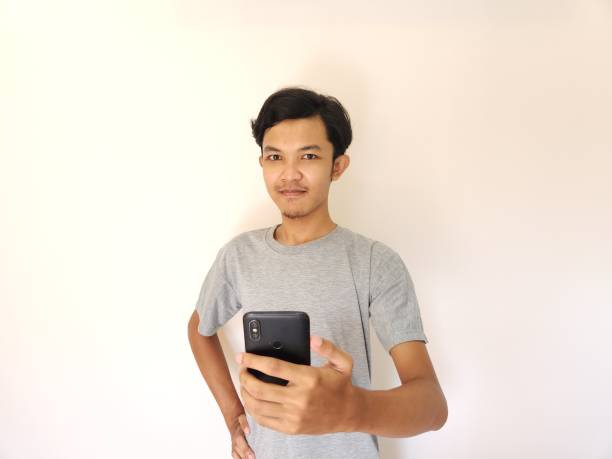 istock Wow and surprise face asian man use smartphone with copy space of advertisement 1484390951