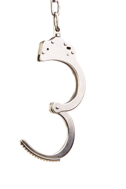 Photo Of Steel Handcuffs On White Background stock photo