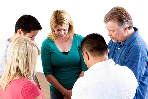 Group Prayer Group of multi-ethnic people praying together. mormon woman photos stock pictures, royalty-free photos & images