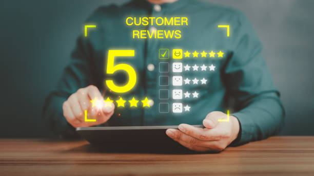 istock Man hand using a tablet with five star icon and pop up smiley face for assessment feedback review satisfaction and testimonial. Customer service experience and business satisfaction survey. 1484409123