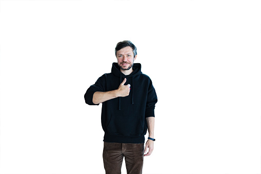 Young bearded smiling handsome man in casual clothes posing isolated on white background and giving thumbs-up
