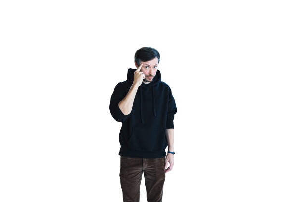 Young bearded handsome man in casual clothes posing isolated on white background and pointing on head with finger