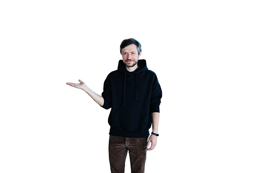 Young bearded smiling handsome man in casual clothes posing isolated on white background and pointing hand in the air