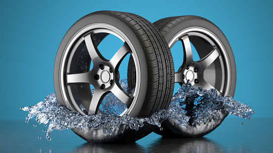 car tires and wheels in water splash  on a blue background. 3d rendering.