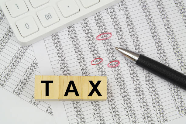istock Word tax on cubes, calculator and pen on documents. 1484427217