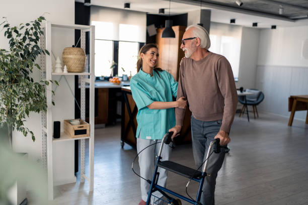 istock Home care worker assisting old man in retirement 1484427943