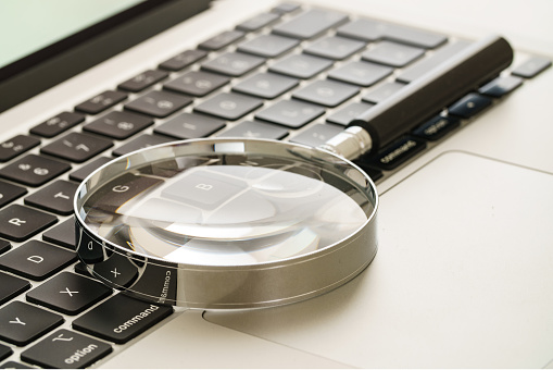 Magnifying glass on computer keyboard