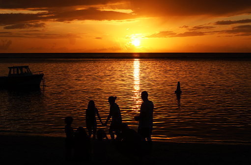 Salvador, Bahia, Brazil - February 14, 2019: People are seen on the beach, in silhouette, having fun during the sunset in the city of Salvador, Bahia.