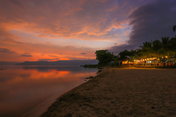 Lake Toba Sunset The beauty of Lake Toba sunset on the south side of the island of Samosir danau toba lake stock pictures, royalty-free photos & images