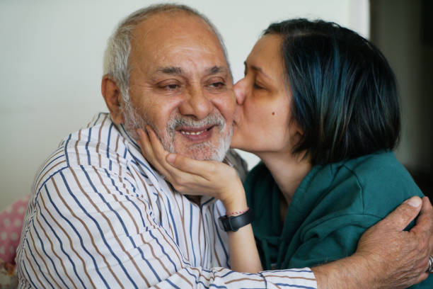 istock senior man kisses daughter on cheek 1484461470