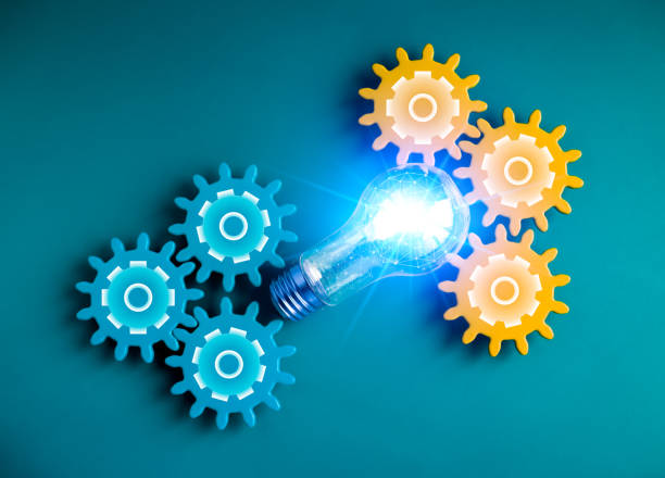 istock Shiny blue light bulb with polygon link inside connected between blue and yellow gear wheels on blue background. Business strategy, management and solution with technology, ai innovation concepts. 1484464482