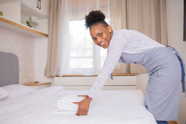 istock Housekeeper is making the bed in the hotel 1484464591