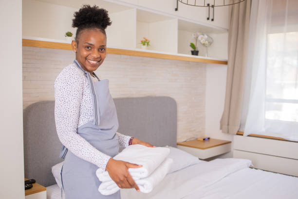 istock Housekeeper is making the bed in the hotel 1484464600