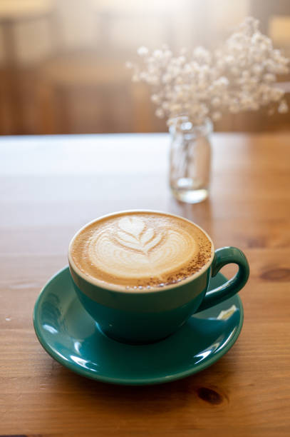 istock Morning Perfection: A Cappuccino with Beautiful Latte Art on a Wooden Table 1484464700