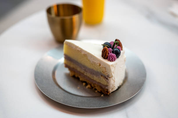 Shot of freshly made Blueberry Cheesecake Slice cake on table.