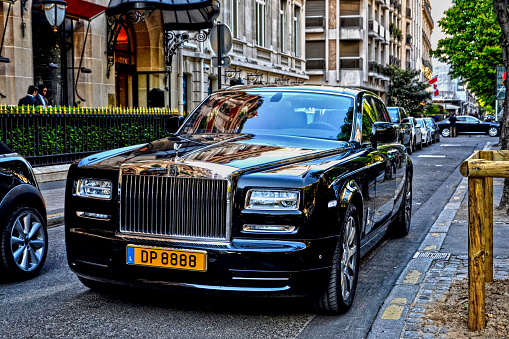 April 18th 2015 : Black Rolls Royce Phantom parked on a street, in George V quarter. It is parked in front of a palace (an international luxury hotel)